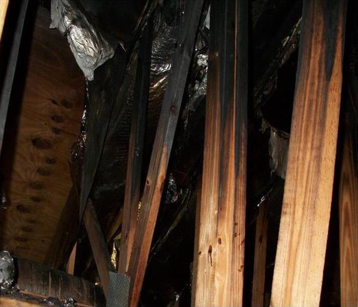 Exposed burned trusses in an attic