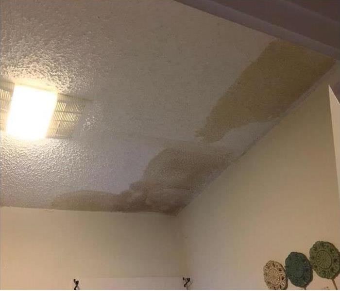 brownish water stains on corner of ceiling and wall 