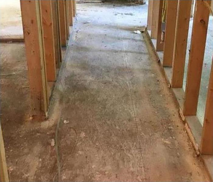 walls exposed and flooring removed during restoration process