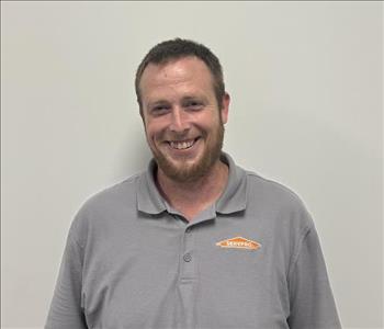 Employee in front of office wall