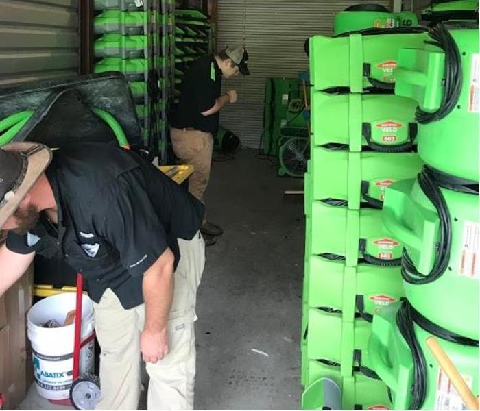 SERVPRO technicians working with restoration equipment in storage facility