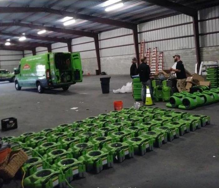 SERVPRO restoration equipment, vehicles, and techs in storage facility